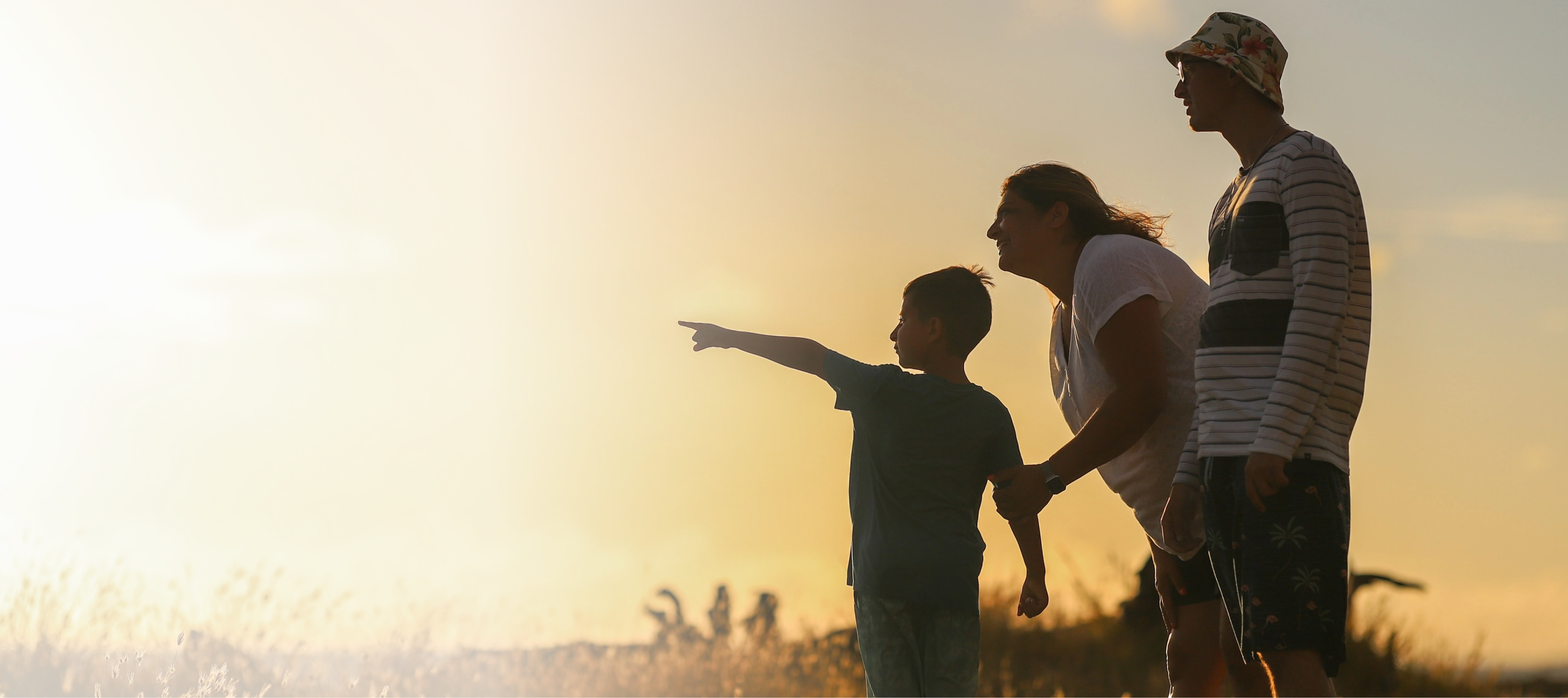 Type 1 Gaucher disease affected family standing outside pointing to the what is type 1 Gaucher disease information