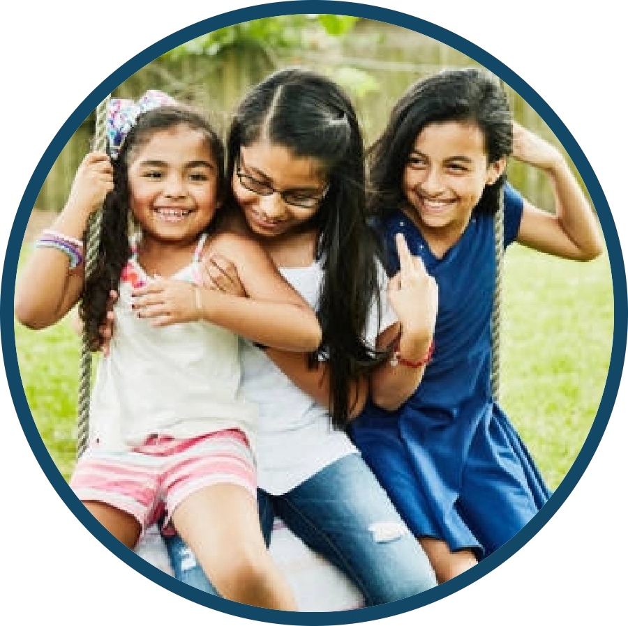 Three happy children sitting on a swing