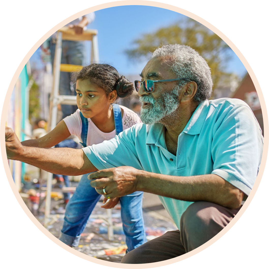 Grandfather and daughter painting a wall